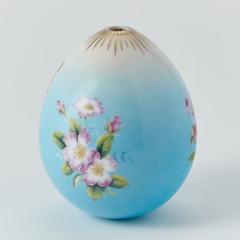 Фарфоровое пасхальное яйцо с изображением шиповника, белого стефанотиса и надписью: «ХВ»